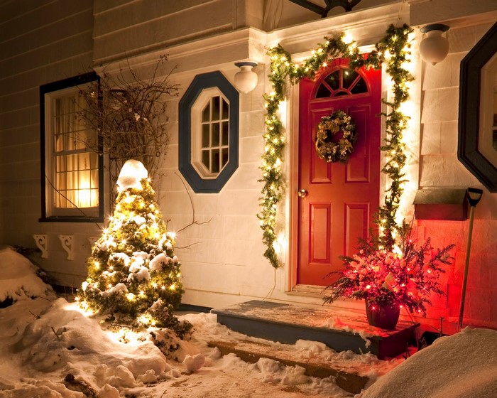 Christmas decorated house entrance with snow