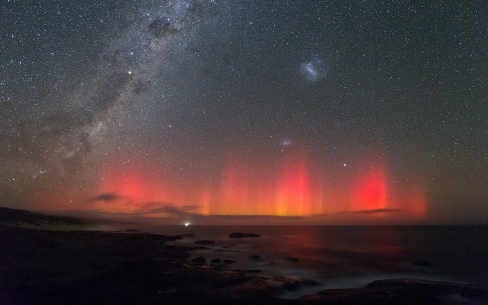 Aurora Borealis over the ocean with the Milky Way
