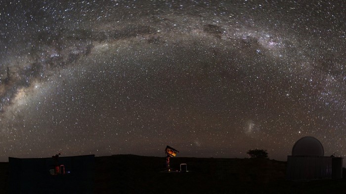 Milky Way galaxy over astronomical observatories at night