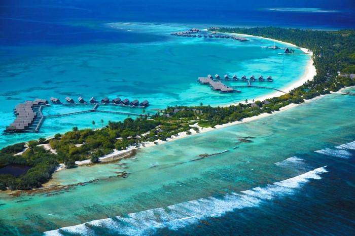 Aerial view of overwater bungalows in a tropical island resort