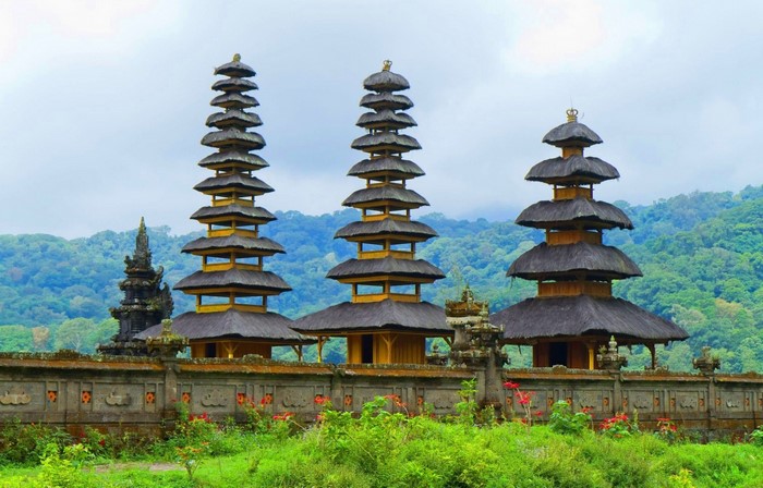 Balinese temples with tiered roofs and lush green hills