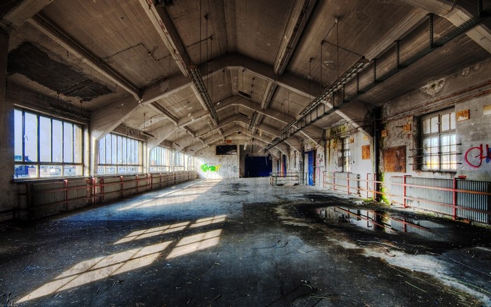 Abandoned industrial building interior with graffiti