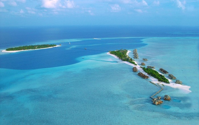 Aerial view of tropical islands and overwater bungalows in the Maldives