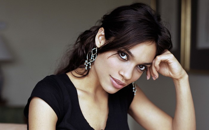 Rosario Dawson portrait with hand on face