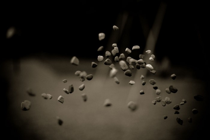 Monochrome macro photography of small stones falling