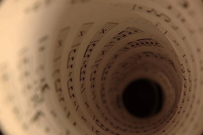 Rolled sheet music in a spiral tunnel effect