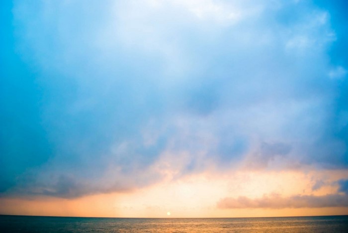 Sunset over the ocean with clouds
