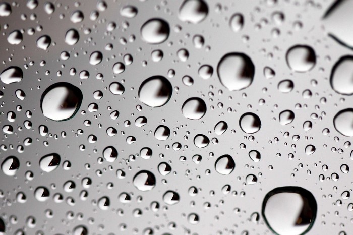 Close-up of water drops on a reflective surface