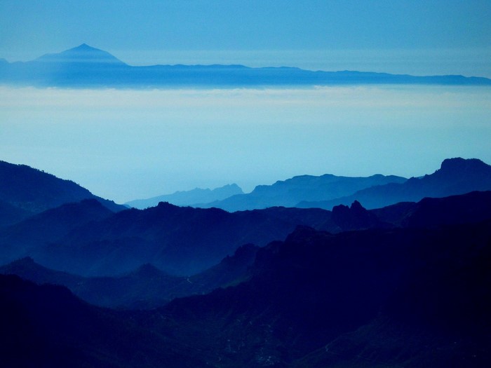 Mountain range with distant peak and clouds