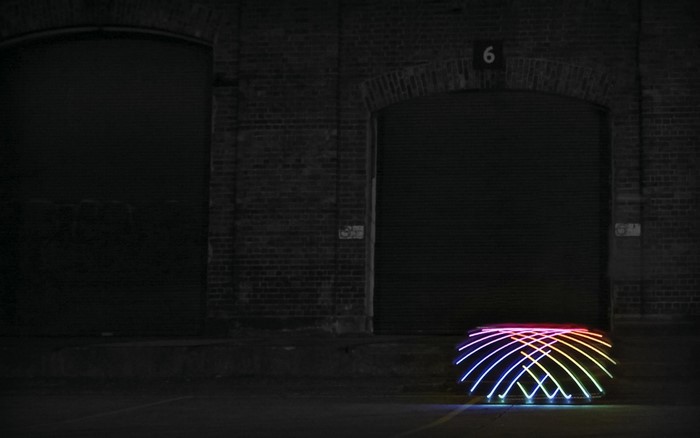 Light painting in front of brick buildings at night