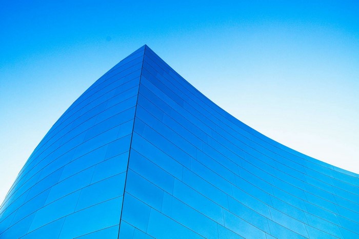 Modern blue building against a clear sky