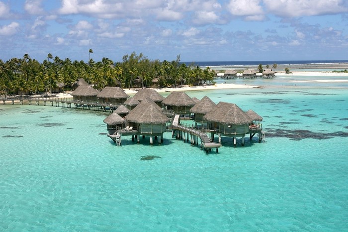 Overwater bungalows in a tropical turquoise lagoon