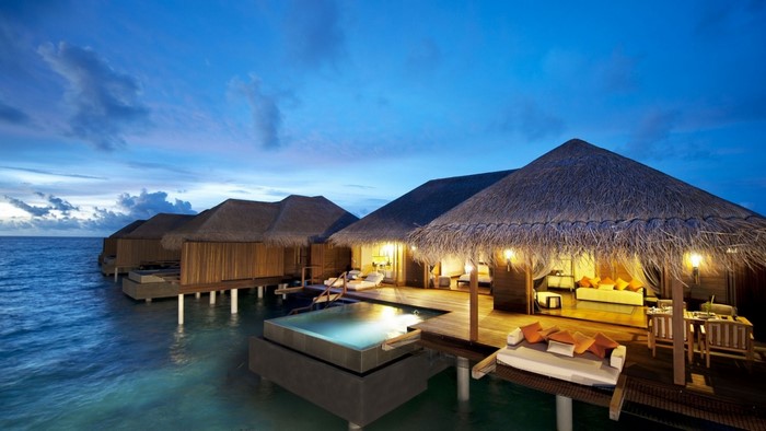 Overwater bungalows with private pool at dusk