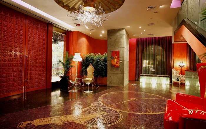 Luxurious hotel lobby with red doors and mosaic floor