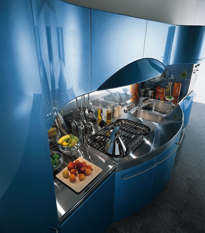 Modern blue curved kitchen with stainless steel appliances