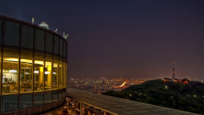 Restaurant overlooking a city at night