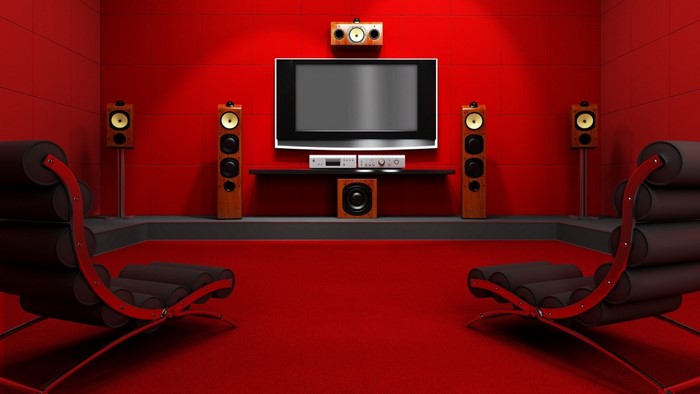 Home theater with red walls, chairs, and speakers