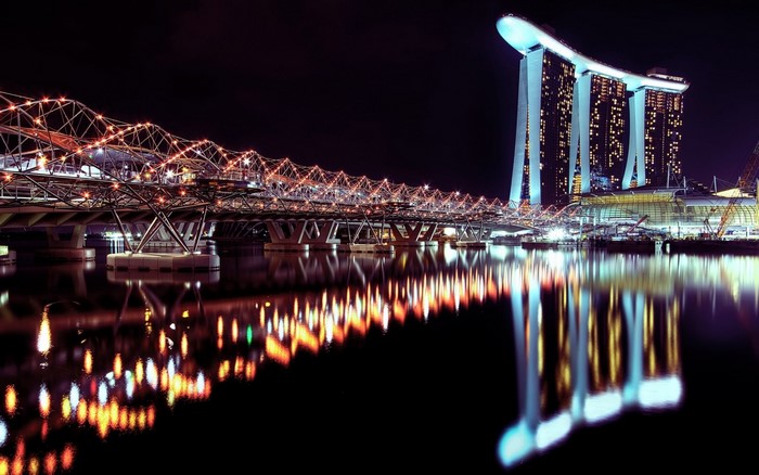 Singapore cityscape at night with illuminated bridge and Marina Bay Sands