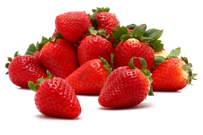 Pile of fresh strawberries on a white background