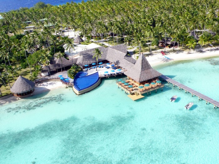 Tropical resort with overwater bungalows and infinity pool