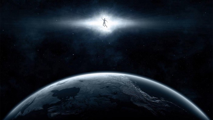 Silhouette of a person floating in space above Earth