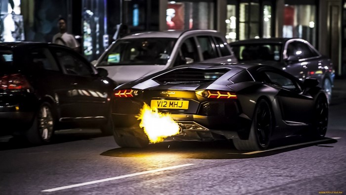 Black Lamborghini Aventador with flames from exhaust