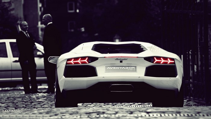 White Lamborghini Aventador LP 700-4 parked on cobblestone street