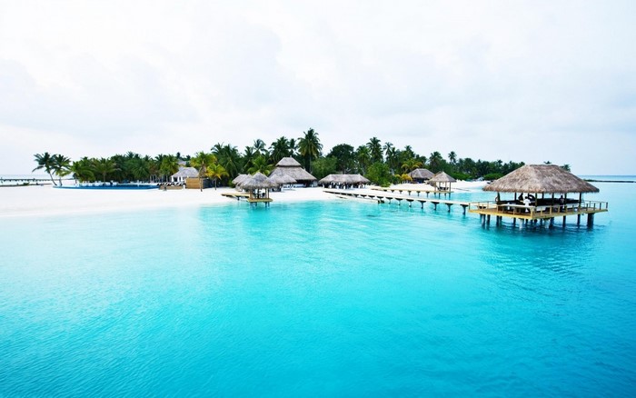 Tropical island resort with overwater bungalows and turquoise water