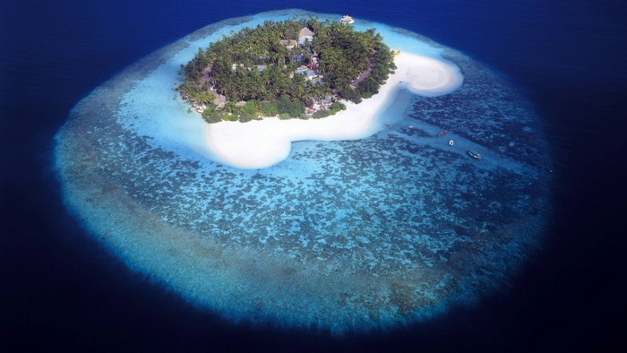 Aerial view of a tropical island with coral reef