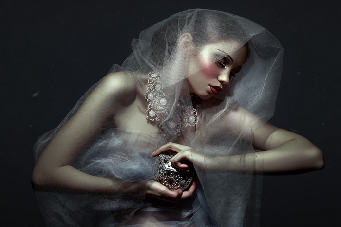 Woman in veil holding ornate box