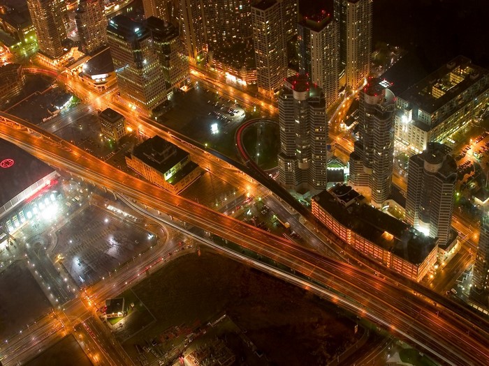 Aerial view of a city at night with highways