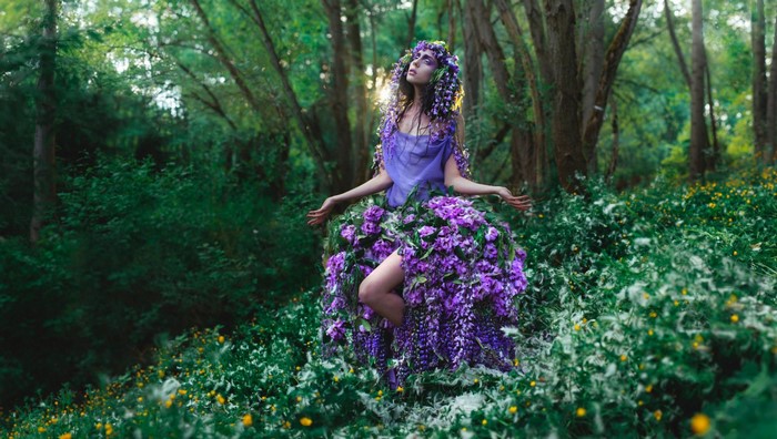 Woman in a flower dress in a forest
