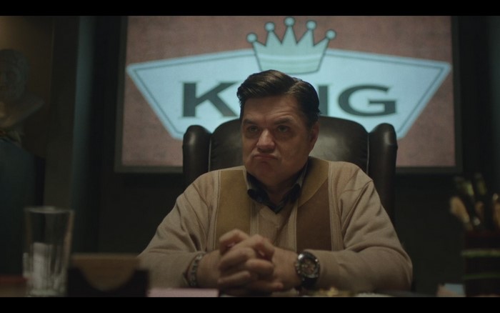Man sitting in office with King logo