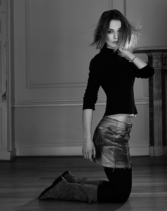 Keira Knightley in a black turtleneck and denim skirt