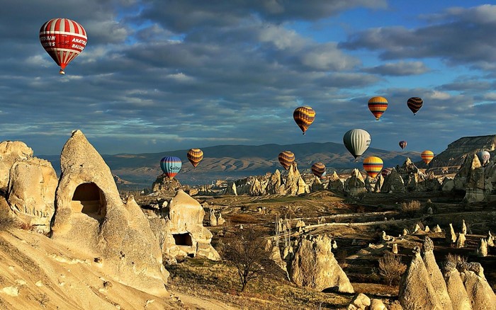 Hot air balloons over Cappadocia landscape