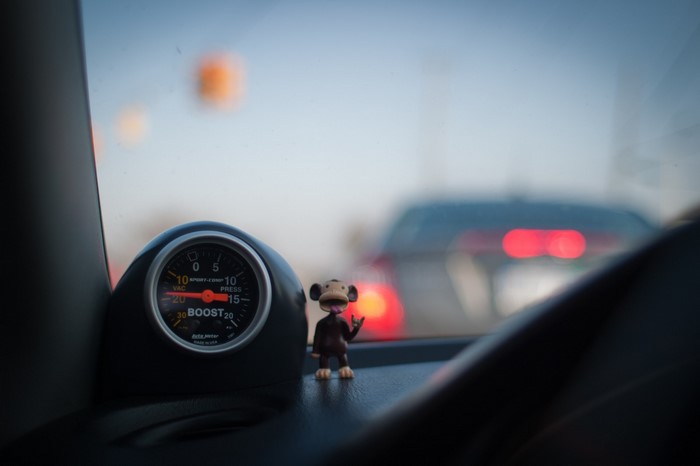 Car interior with boost gauge and monkey toy