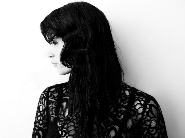 Woman with black hair and lace top