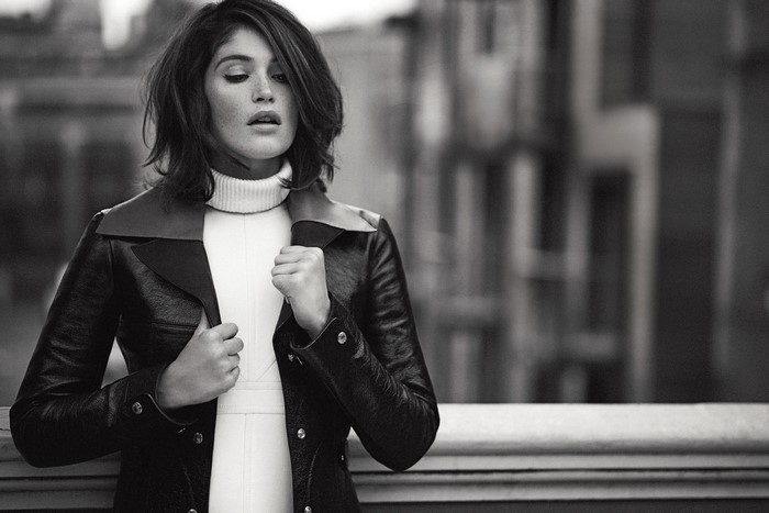 Gemma Arterton in a black leather jacket and white turtleneck