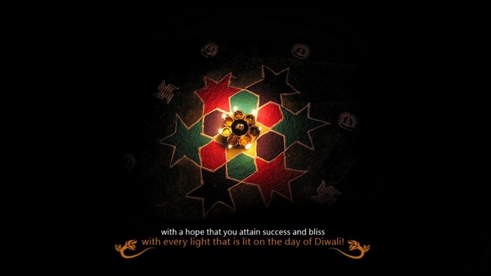 Diwali greeting with lit diyas and rangoli