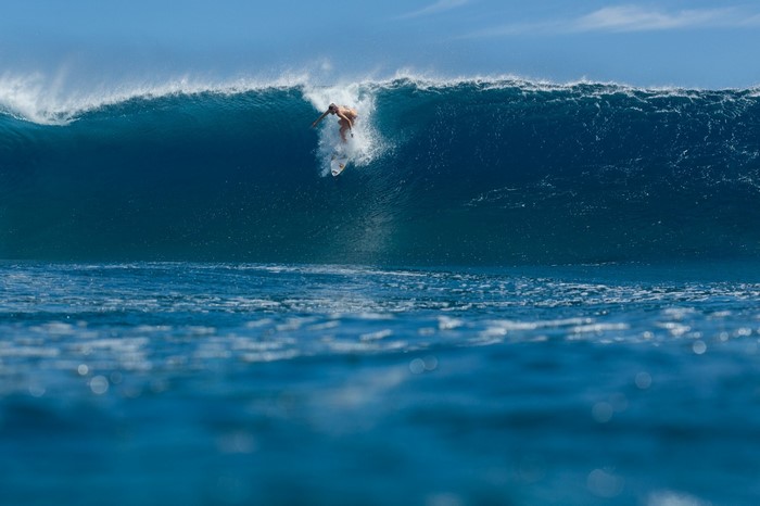 Surfer riding a large wave in the ocean
