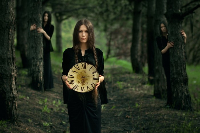 Women in a forest holding a clock