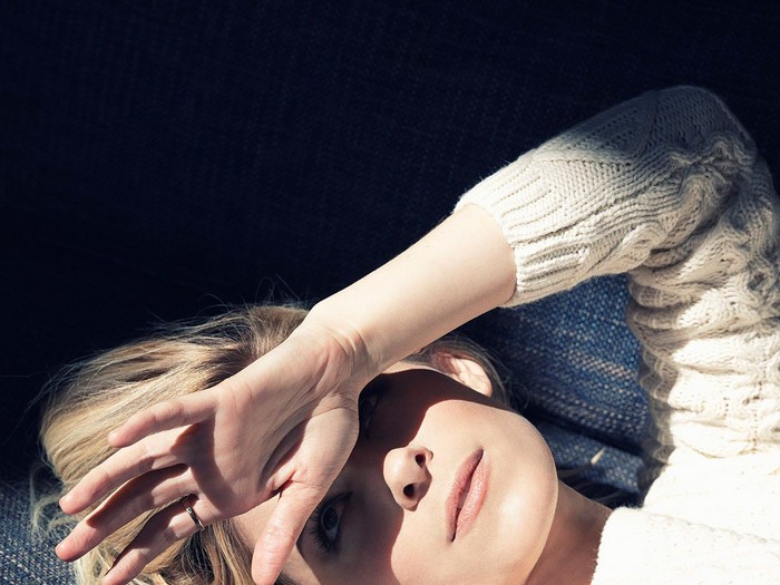 Woman with hand over face