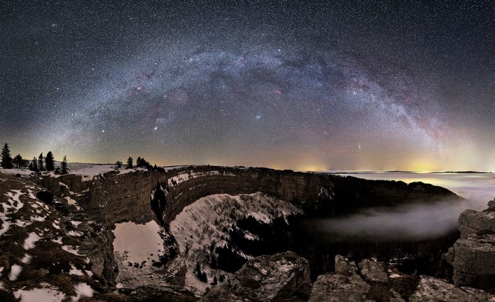 Milky Way over a snowy canyon at night