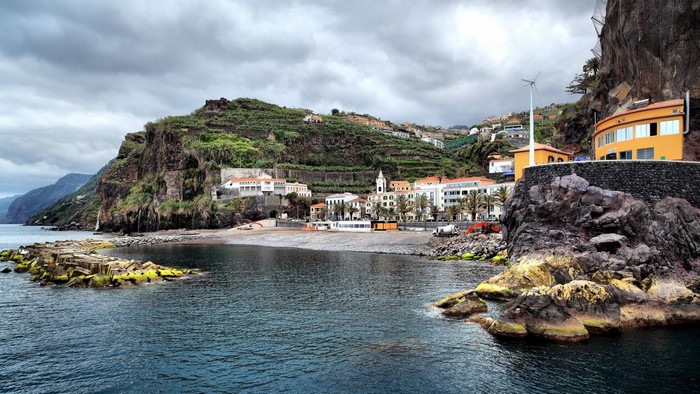 Coastal town nestled against cliffs by the sea