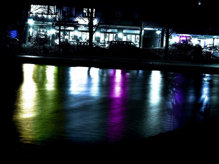 Colorful reflections of lights on water at night