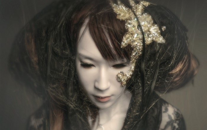 Woman with elaborate hair and gold decoration