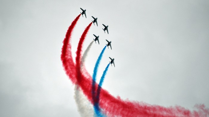 Patrouille de France jets performing aerobatics with red, white, and blue smoke