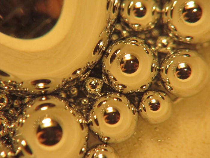 Close-up of metallic beads reflecting light