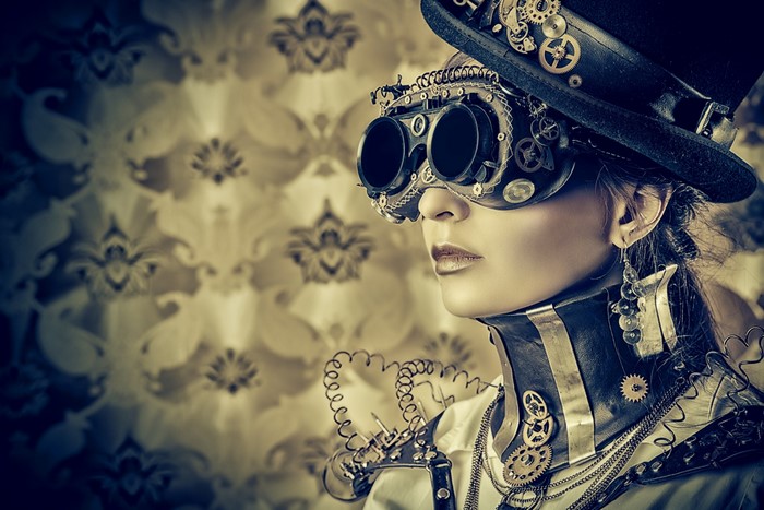 Steampunk woman wearing goggles and top hat