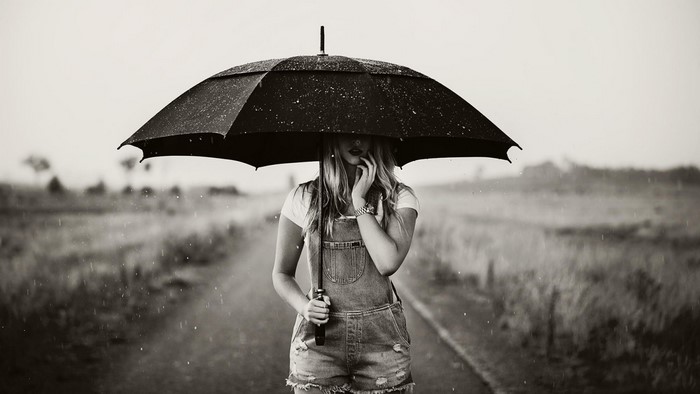 Woman holding umbrella in the rain